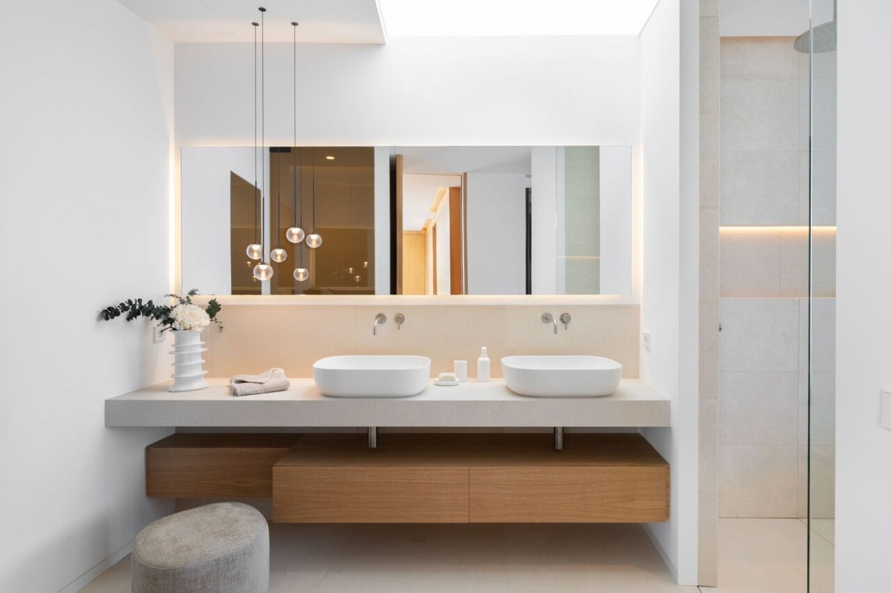 Contemporary bathroom with double vanity, illuminated mirror and walk-in shower