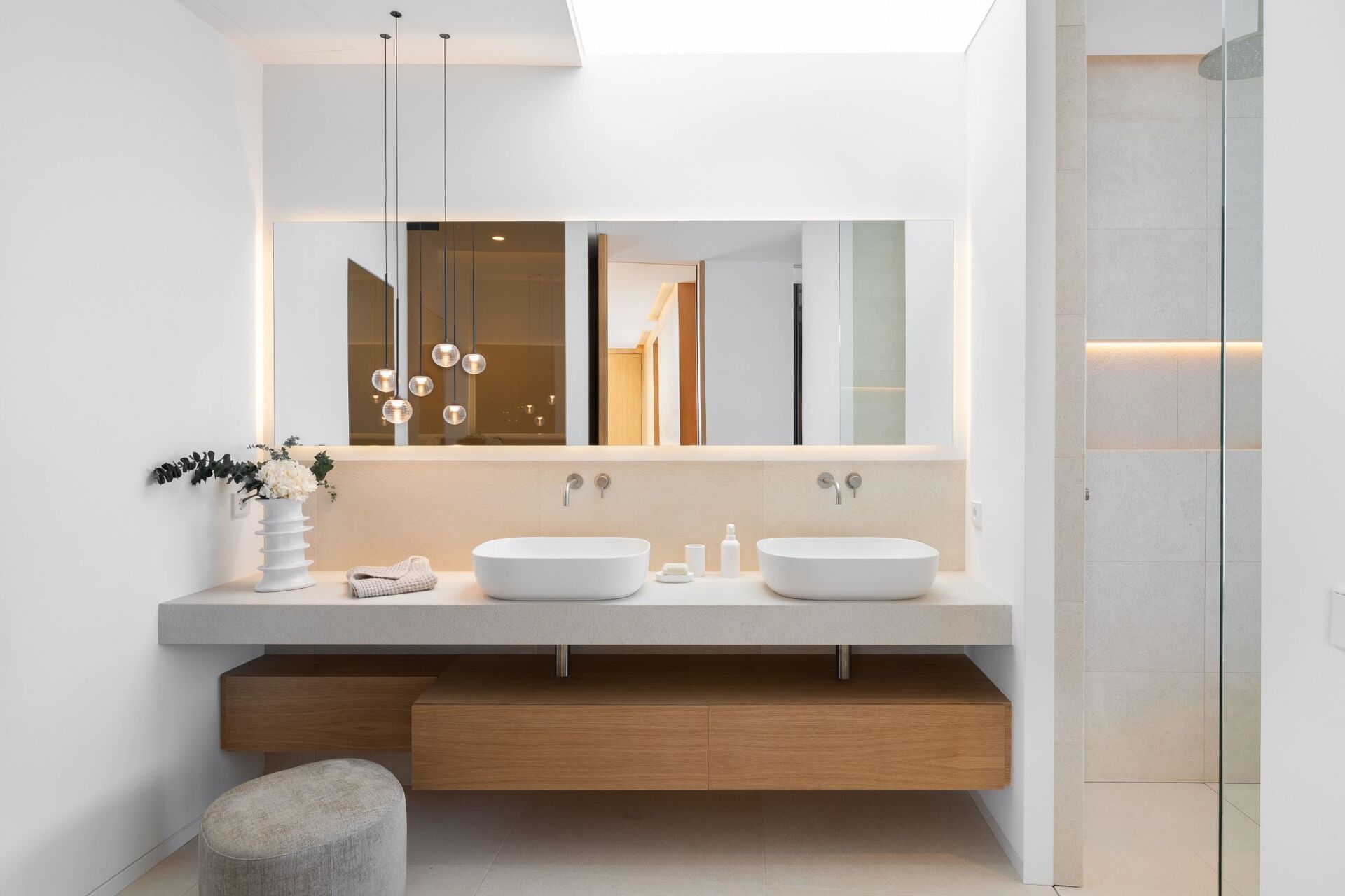 Contemporary bathroom with double vanity, illuminated mirror and walk-in shower
