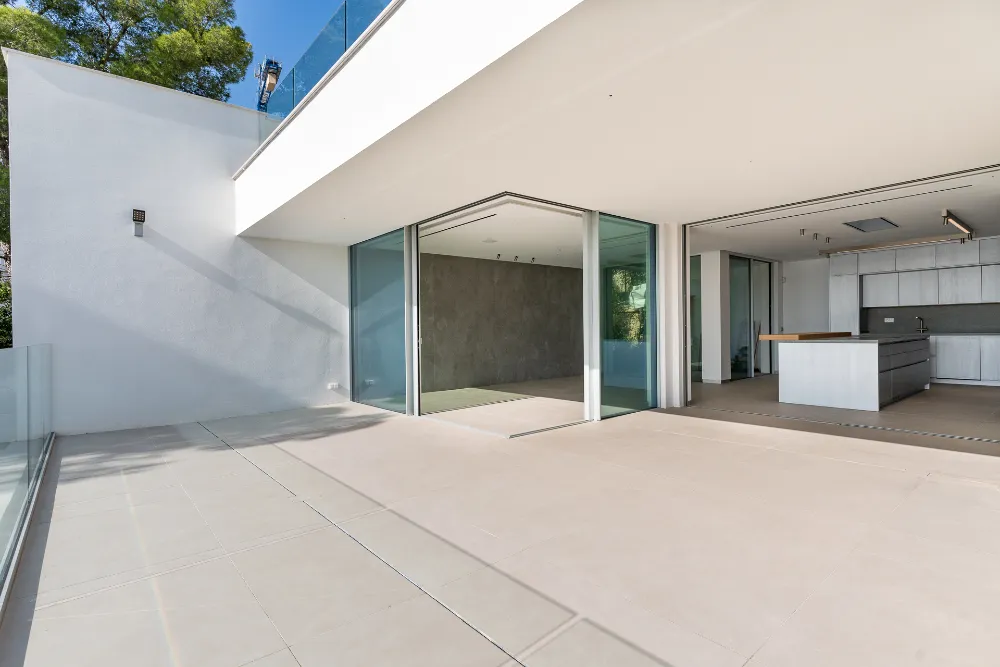 Covered terrace opening into the modern kitchen and living area