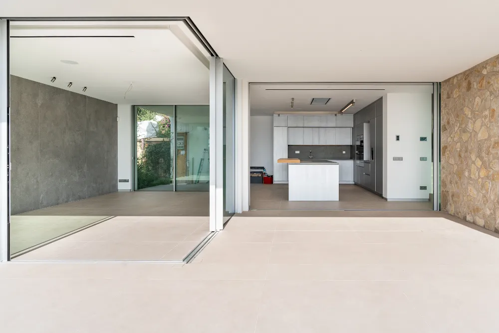 Modern kitchen opening onto a bright covered terrace