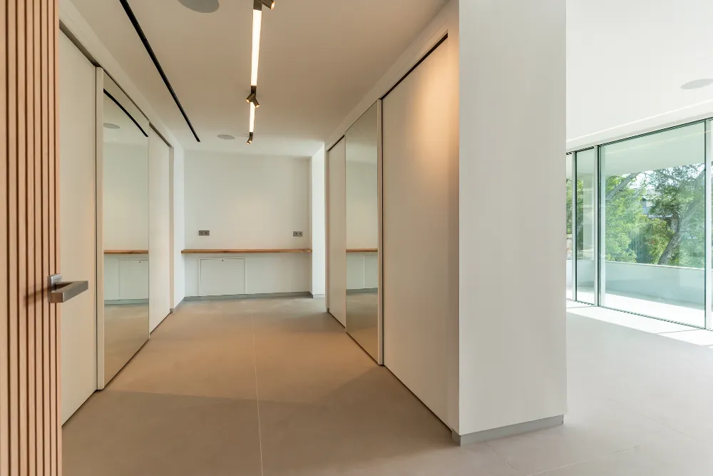 Bright hallway with built-in wardrobes, oak door and glass wall