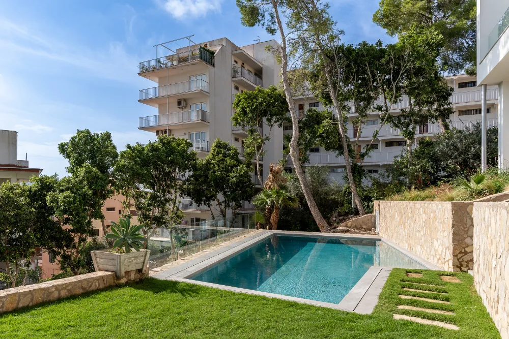 Private pool garden with stone paths, glass railing and mature trees